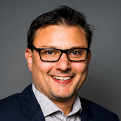 Danny Markham - Business Headshot wearing rectangular glasses and dark navy business suit