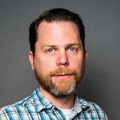 Ian Miller - Business Headshot light blue plaid shirt on gray background