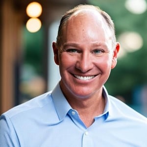 Shawn Conahan - Business Headshot light blue button up blurred nature appearing background